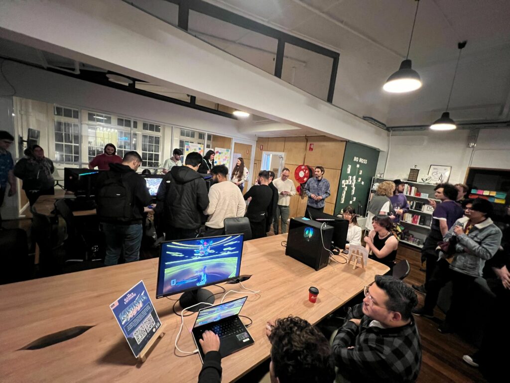 A photo of the crowd in our office, with some folks playing Katana Rama in the foreground.