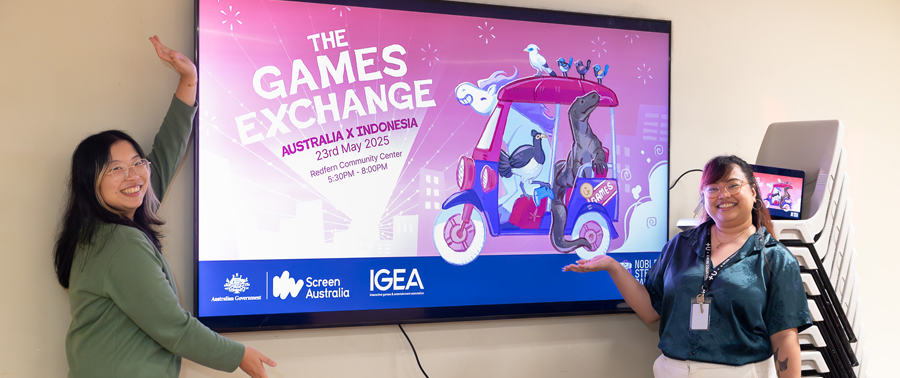 A photo of Ann and Christine in front of the Games Exchange banner.